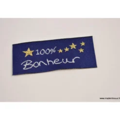 Etiquette tissée à coudremessage "100% Bonheur" 20x45mm