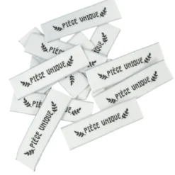 Etiquette tissée pré-pliée à coudre message "PIECE UNIQUE" 14x48mm