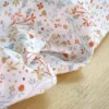 Sergé de coton Camilia motif fleurs, oiseaux et fruits fond blanc