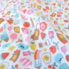 Tissu coton enduit Kawi motifs kawaii multicolores