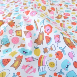 Tissu coton enduit Kawi motifs kawaii multicolores