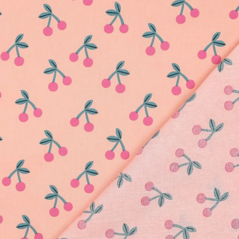 Tissu coton Enduit motifs cerises fond rose