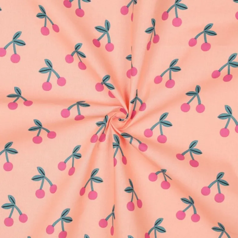 Tissu coton Enduit motifs cerises fond rose