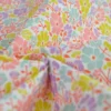 Tissu coton enduit petites fleurs roses et parme fond blanc - Poppy