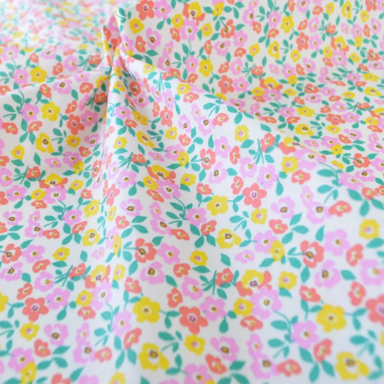 Tissu coton Enduit Thalie motif fleurs roses et jaunes