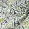 Tissu coton Lion motif petites feuilles exotiques vertes fond blanc