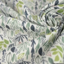 Tissu coton Lion motif petites feuilles exotiques vertes fond blanc