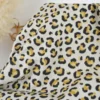 Tissu demi natté coton motif léopard doré fond aspect lin