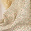 Tissu double gaze de coton Caseille fleurs rose fluo fond écru