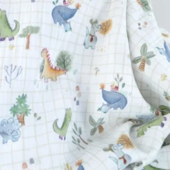 Tissu double gaze de coton Ceradino motif dinosaures fond à carreaux blanc