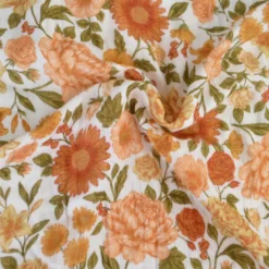Tissu double gaze de coton Elisabeth motif fleurs tons orangés et rose
