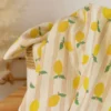 Tissu double gaze de coton Lime motif citrons et rayures fond écru