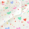 Tissu double gaze de coton Tiamo motif coeurs fond écru