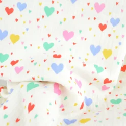 Tissu double gaze de coton Tiamo motif coeurs fond écru