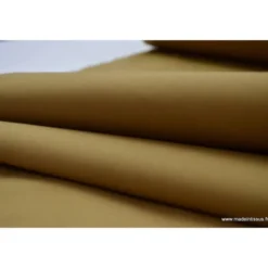 Tissu Gabardine enduite étanche camel.