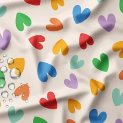 Tissu imperméable Chrichri type ciré motif coeurs multicouleurs