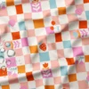 Tissu imperméable Cirafine type ciré motif carreaux écru et rose