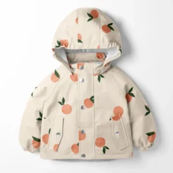Tissu imperméable type ciré motif fruits fond rose clair