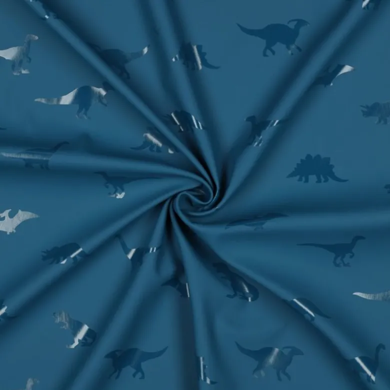 Tissu imperméable type ciré motif dinosaures fond bleu