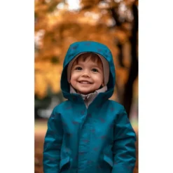 Tissu imperméable type ciré motif dinosaures fond bleu