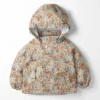 Tissu imperméable type ciré motif fleurs fond blanc cassé