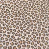 Tissu imperméable type ciré motif léopard fond écru
