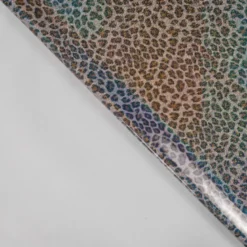 Tissu imperméable type ciré motif léopard à paillettes