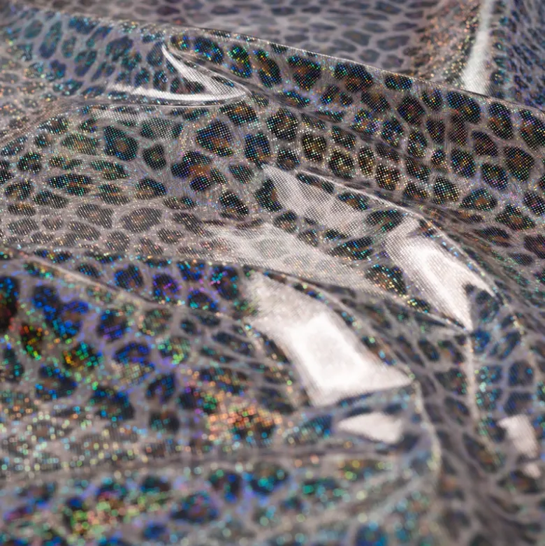 Tissu imperméable type ciré motif léopard à paillettes