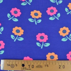 Tissu jersey coton Poppy motif fleurs rose fluo - fond Cobalt
