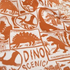 Tissu jersey coton Poppy motif dinosaures camel fond blanc