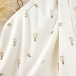 Tissu jersey côtelé fines côtes – Motif fleurs montgolfières fond blanc cassé