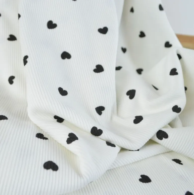 Tissu jersey côtelé motif coeurs Noirs fond blanc