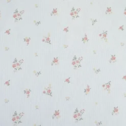 Tissu jersey côtelé motif fleurs roses fond blanc cassé