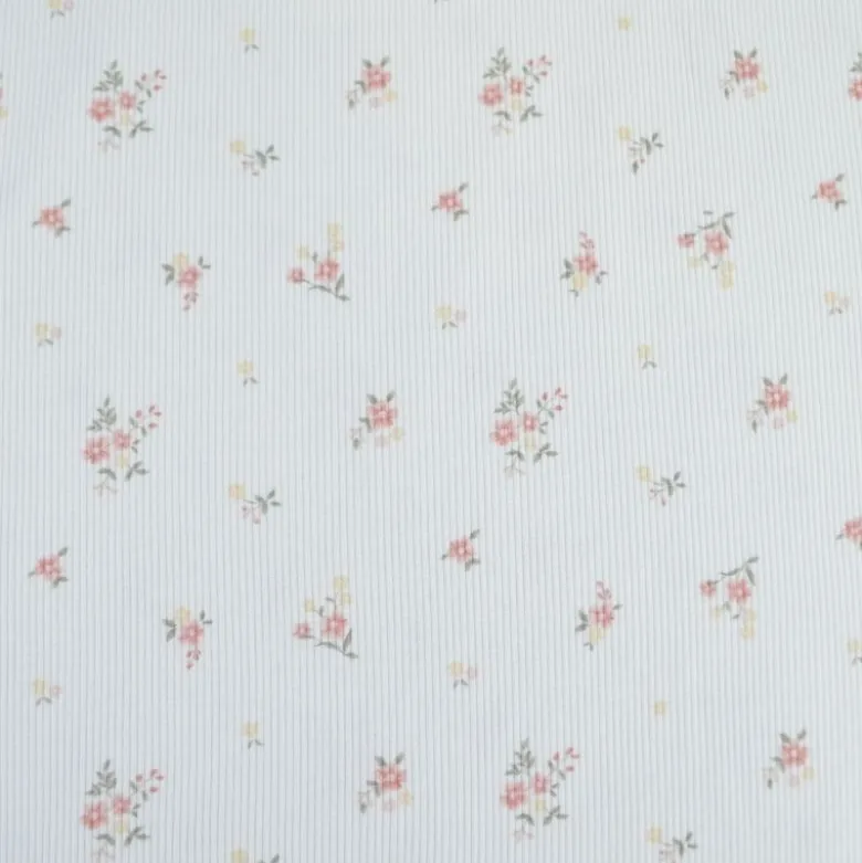 Tissu jersey côtelé motif fleurs roses fond blanc cassé