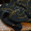 Tissu Jersey milano motif chaines dorés fond noir