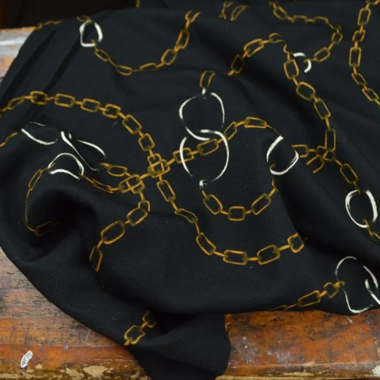 Tissu Jersey milano motif chaines dorés fond noir