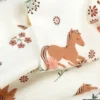 Tissu jersey motifs chevaux et fleurs fond blanc cassé - OEKO TEX
