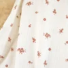 Tissu maille pointelle coton motif petites fleurs terracotta fond écru