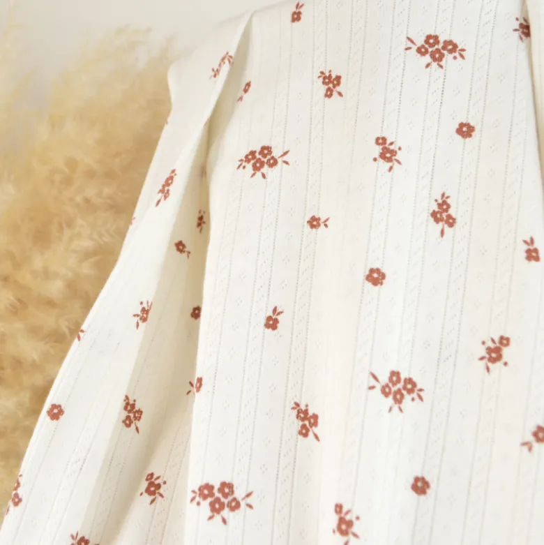 Tissu maille pointelle coton motif petites fleurs terracotta fond écru