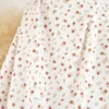Tissu maille pointelle motif petites fleurs terracotta – fond blanc cassé