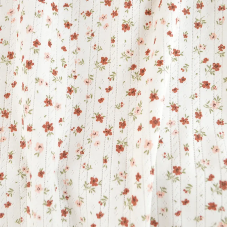 Tissu maille pointelle motif petites fleurs terracotta – fond blanc cassé