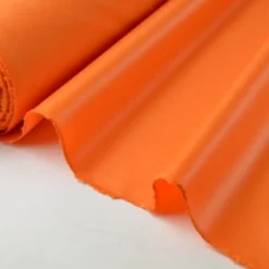 Tissu polyester orange déperlant pour parapluie .