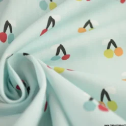 Tissu popeline Esteve motif cerises fond bleu