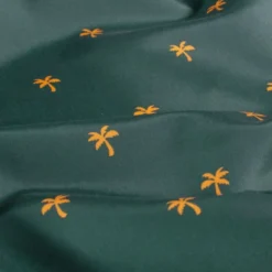Tissu pour short de bain déperlant motif palmiers fond pétrole