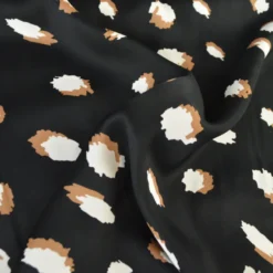 Tissu Satin de viscose motif leopard camel fond Noir
