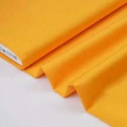 Tissu satin microfibre fluide uni moutarde