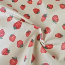 Tissu toile enduite aspect lin motif fraises
