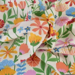 Tissu toile imprimée fleurs multicolores sur fond écru