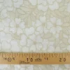Tissu voile de coton brodé beige motif fleurs fond sable