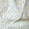 Voile plumetis rayures et citrons fond écru